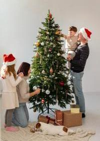 beautiful family decorating christmas tree